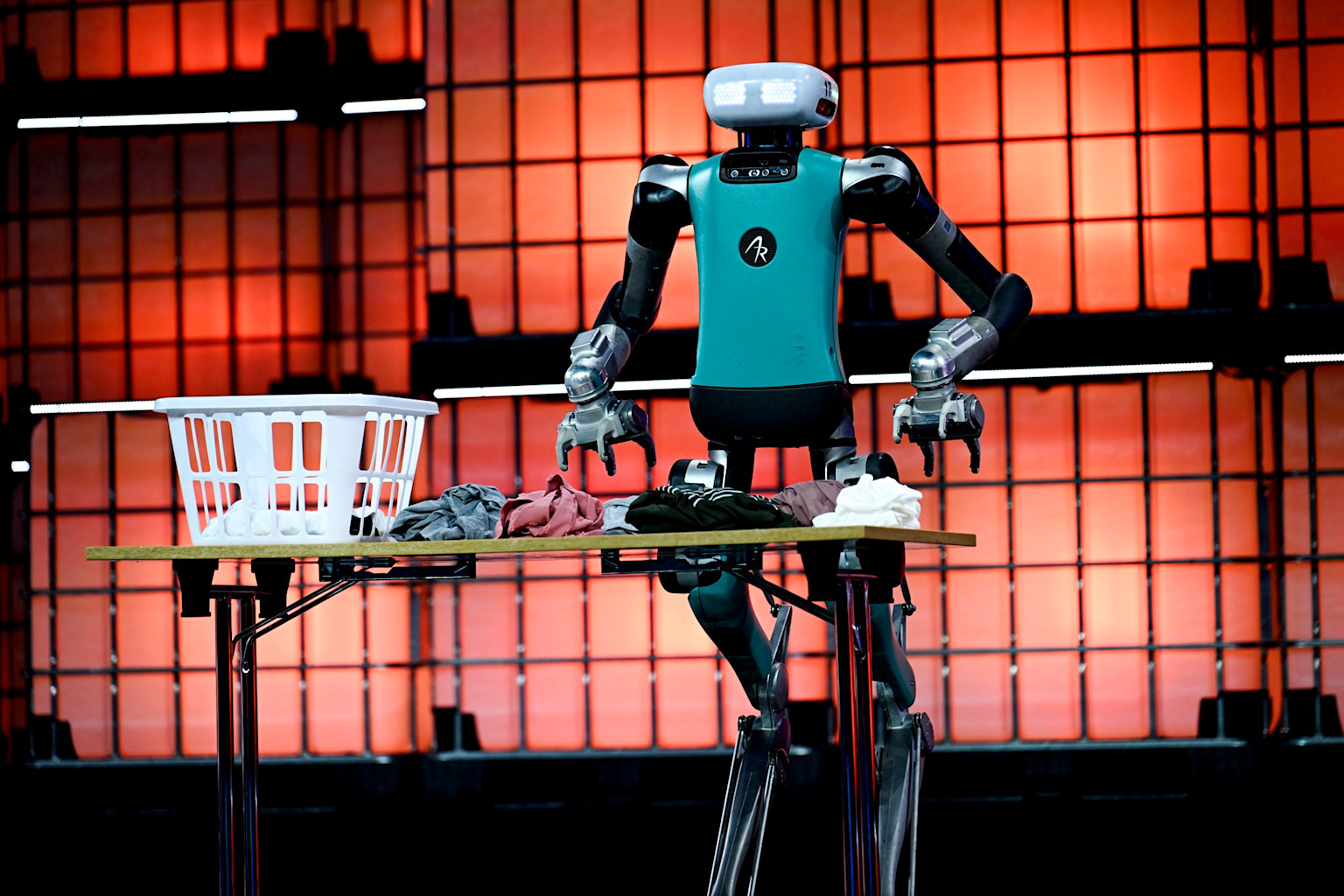 A 2025-era humanoid robot demonstrates folding laundry, showcasing advancements in AI and robotics technology